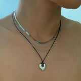 Collar de cadena y corazón perfectamente superpuesto