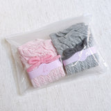 Set of two cozy socks featuring soft yarn bow accents, combining comfort with a touch of playful charm.