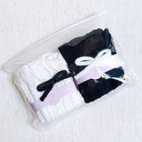Set of two cozy socks featuring soft yarn bow accents, combining comfort with a touch of playful charm.