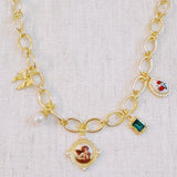 Chunky gold-link necklace featuring a mix of whimsical charms including an angel, rose, and gem accents—blending vintage elegance with romantic flair.