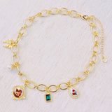 Chunky gold-link necklace featuring a mix of whimsical charms including an angel, rose, and gem accents—blending vintage elegance with romantic flair.