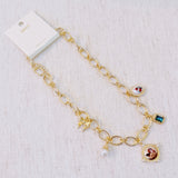 Chunky gold-link necklace featuring a mix of whimsical charms including an angel, rose, and gem accents—blending vintage elegance with romantic flair.