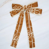 Stylish bow hair clip featuring decorative contrast stitching and a structured design—adding a touch of handcrafted charm and elegance to any hairstyle.