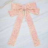 Stylish bow hair clip featuring decorative contrast stitching and a structured design—adding a touch of handcrafted charm and elegance to any hairstyle.