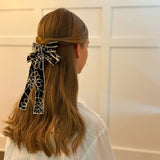 Stylish bow hair clip featuring decorative contrast stitching and a structured design—adding a touch of handcrafted charm and elegance to any hairstyle.