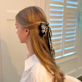 Stylish bow hair clip featuring decorative contrast stitching and a structured design—adding a touch of handcrafted charm and elegance to any hairstyle.