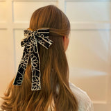 Stylish bow hair clip featuring decorative contrast stitching and a structured design—adding a touch of handcrafted charm and elegance to any hairstyle.