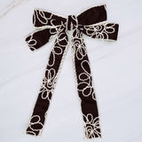 Stylish bow hair clip featuring decorative contrast stitching and a structured design—adding a touch of handcrafted charm and elegance to any hairstyle.