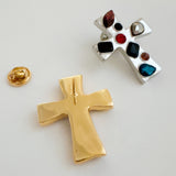 Elegant cross-shaped brooch pin with an artisan-inspired design, featuring sculpted edges and a smooth metallic finish available in gold or silver tones, perfect for adding a refined accent to jackets, scarves, or bags.
