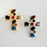 Elegant cross-shaped brooch pin with an artisan-inspired design, featuring sculpted edges and a smooth metallic finish available in gold or silver tones, perfect for adding a refined accent to jackets, scarves, or bags.