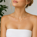 Woman wearing a pearl necklace with a blurred background
