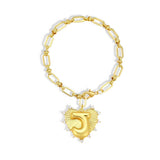 Gold chain bracelet with a heart-shaped charm and initial letter J over the heart charm on a white background