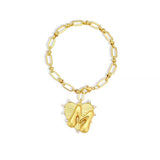 Gold chain bracelet with a heart-shaped charm and initial letter M over the heart charm on a white background