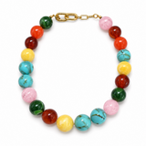 A multicolor beaded necklace with polished round beads in turquoise, pink, red, orange, yellow, and green, finished with a gold clasp, shown on a white background.