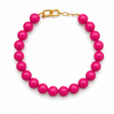Pink beaded bracelet with a gold clasp on a white background