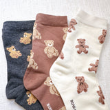 Cute and cozy set of three socks featuring playful bear designs in soft, neutral tones—perfect for adding a touch of whimsy to your everyday look.