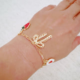 Gold charm bracelet with strawberry, heart, and bow – romantic playful bracelet