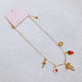 Gold charm bracelet with strawberry, heart and bow – romantic playful bracelet