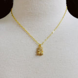 Sparkling gold-tone necklace featuring a playful bear-shaped pendant encrusted with shimmering rhinestones.