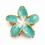 Flower shaped hair claw gold outlined green enamel petals with white center