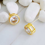 Statement stud earrings featuring bold bezel-set stones, designed to deliver striking sparkle and a sleek, modern silhouette for everyday elegance or special occasions.