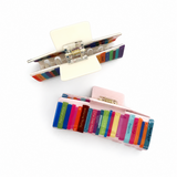 Colorful hair clip with rainbow design on a white background
