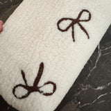 Small fleece zip bag with embroidered fuzzy bows, perfect for cosmetics or travel essentials