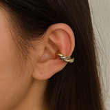 Chunky ear cuff featuring an interwoven braided design in gold and silver tones—delivering a bold, no-piercing look with modern mixed-metal appeal.
