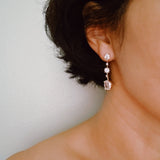 Elegant drop earrings featuring brilliant cubic zirconia stones in a sleek, cascading design, delivering radiant sparkle with every movement for a refined and timeless look.
