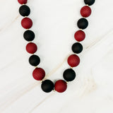 Necklace with black and red beads on a white background