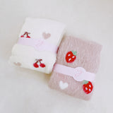 Set of two fuzzy socks featuring cute cherry and strawberry designs, adding a sweet and cozy touch to your loungewear.