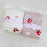 Set of two fuzzy socks featuring cute cherry and strawberry designs, adding a sweet and cozy touch to your loungewear.