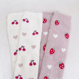 Set of two fuzzy socks featuring cute cherry and strawberry designs, adding a sweet and cozy touch to your loungewear.