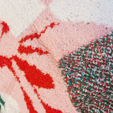 Close-up of a textured surface with red, green, and white patterns.