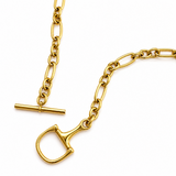 Close up to Gold toggle clasp chain necklace with mixed oval and round links in a polished yellow gold finish, styled in a modern minimal silhouette on a white background.