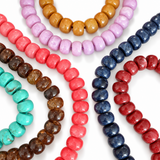 Multiple colors of beaded necklaces on the white background.