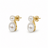 Pair of pearl earrings with gold clasps on a white background