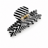 Black and white striped hair clip on a white background
