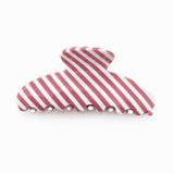 Red and white striped hair clip on a white background