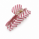 Pink and white striped hair clip on a white background