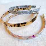 Slim and sleek headband with a classic tortoise shell pattern—offering a timeless, polished look perfect for everyday wear or chic styling.