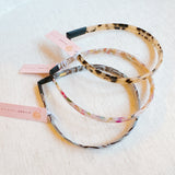 Slim and sleek headband with a classic tortoise shell pattern—offering a timeless, polished look perfect for everyday wear or chic styling.
