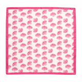 Pink shell patterned fabric square on a white background. Lightweight square scarf featuring an allover seashell print with a coordinating border, designed for versatile styling around the neck, hair, or handbag.