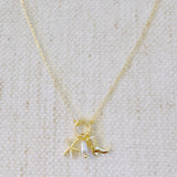 Gold-tone chain necklace adorned with a starfish charm and a western boot charm, capturing a playful blend of coastal and cowgirl vibes.