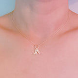 Gold-tone chain necklace adorned with a starfish charm and a western boot charm, capturing a playful blend of coastal and cowgirl vibes.