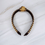 Raffia headband with vibrant color-stitched detail in a knotted design, offering a fun and summery look.