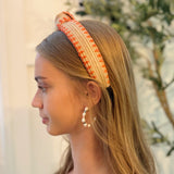 Raffia headband with vibrant color-stitched detail in a knotted design, offering a fun and summery look.