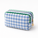 A blue and white gingham fabric cosmetic case with green wavy details on top, gold zipper and daisy shape zipper pull, white background