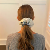 Stylish hair scrunchie featuring a bold cheetah print with delicate crochet trim, blending wild flair with a touch of handcrafted charm.
