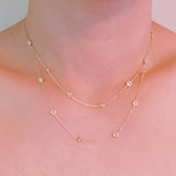 Elegant layered necklace featuring delicate gold chains accented with crystal bezel stations, perfect for a subtle sparkle and refined style.
